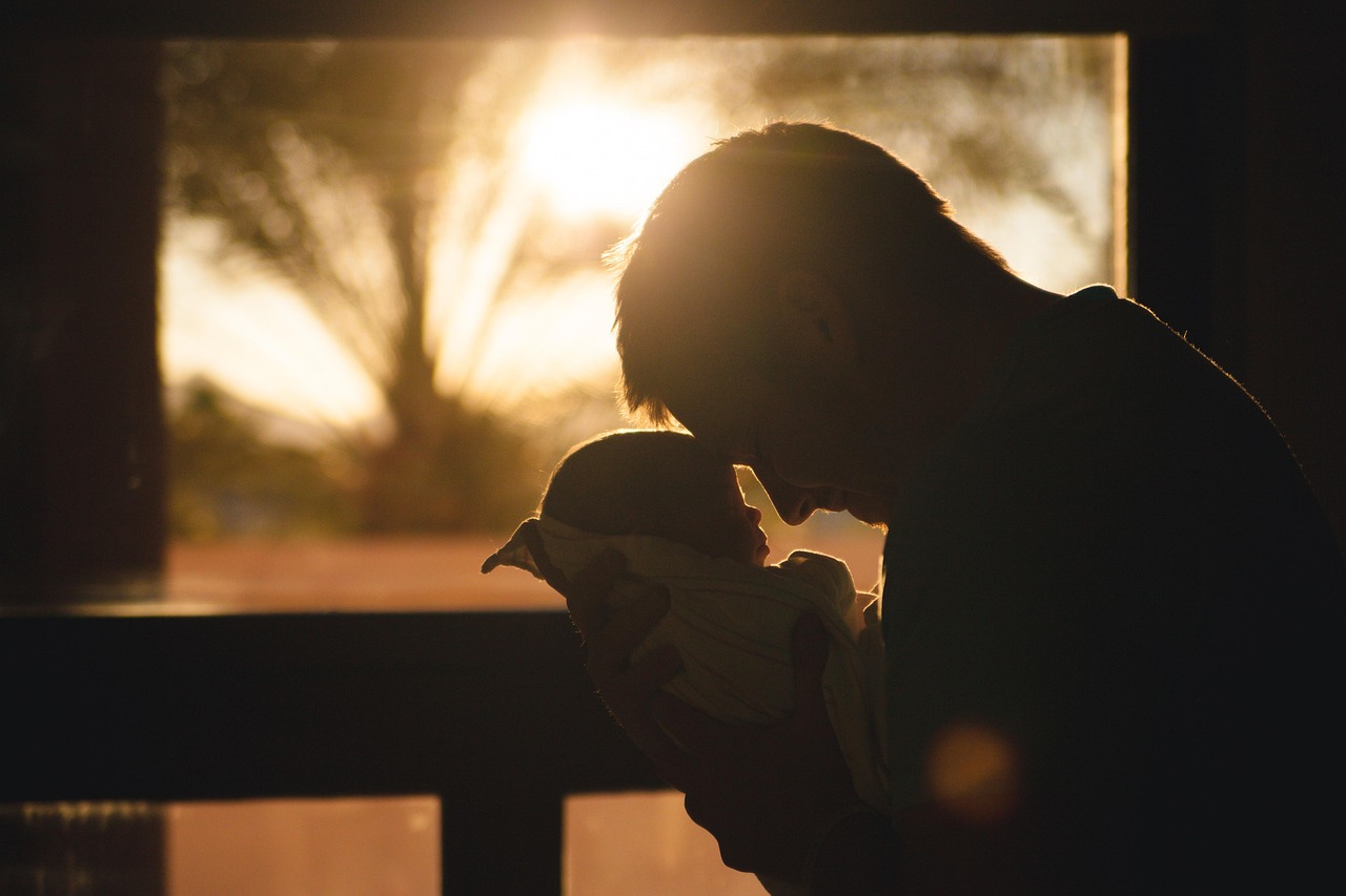 Father holding baby during medical visit