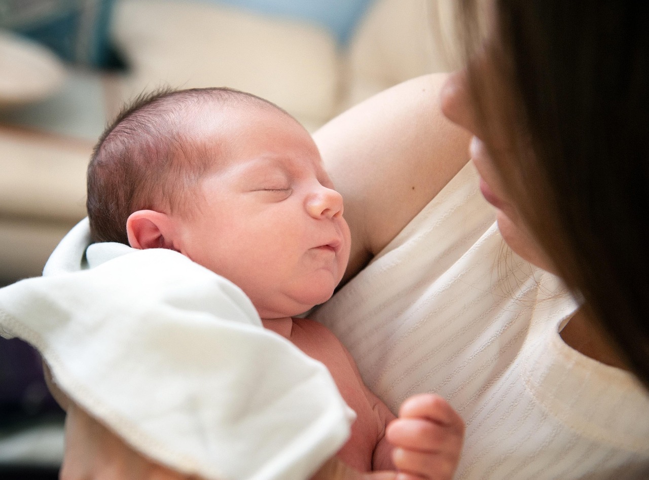 Mother holding baby after medical procedure